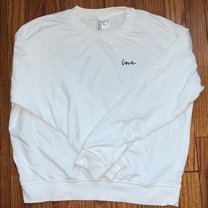 White “love” sweatshirt.